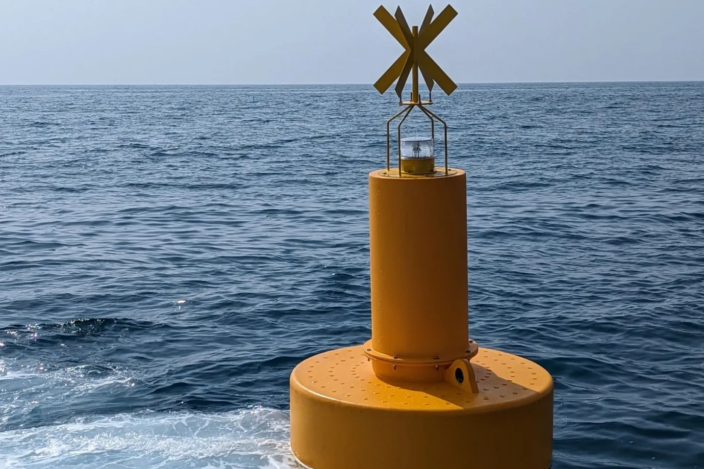 Polyethylene navigation buoy at sea used as an aid to navigation, showing the durability and corrosion resistance of polyethylene vs steel buoys.
