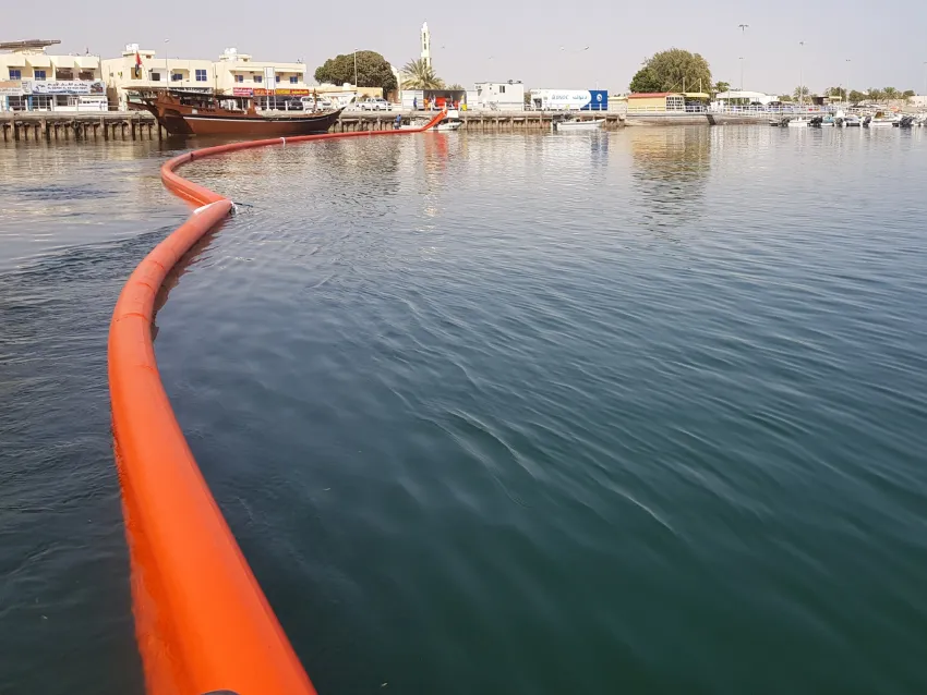 Inflatable oil boom deployed in harbor
