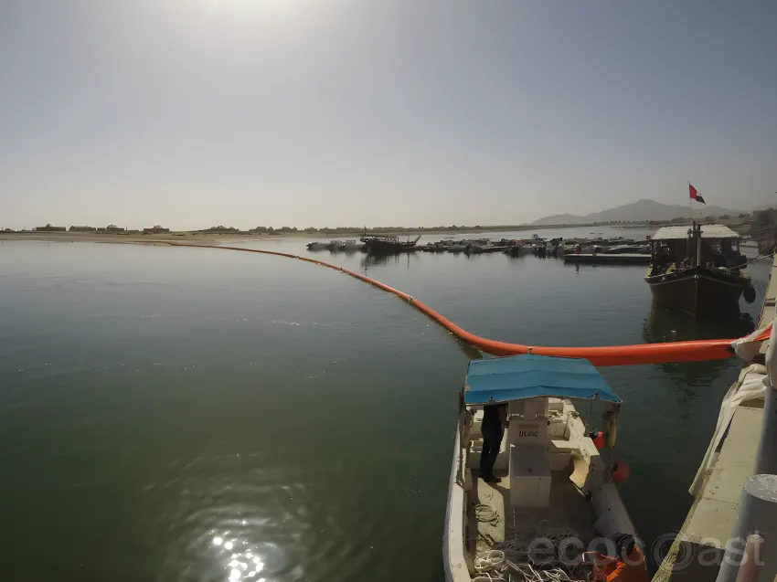 Inflatable oil boom deployed in harbor water