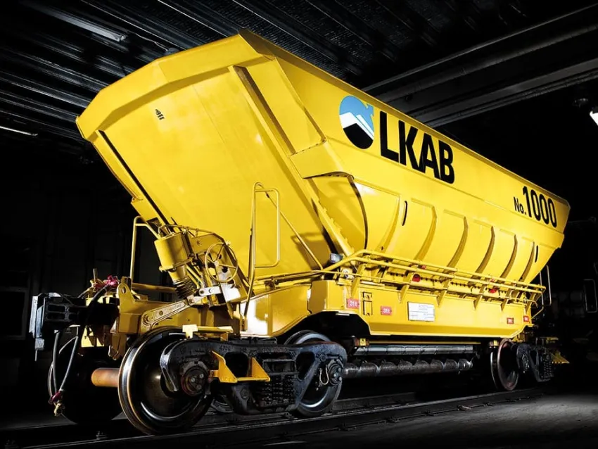 Yellow bottom dumper wagon on rail track