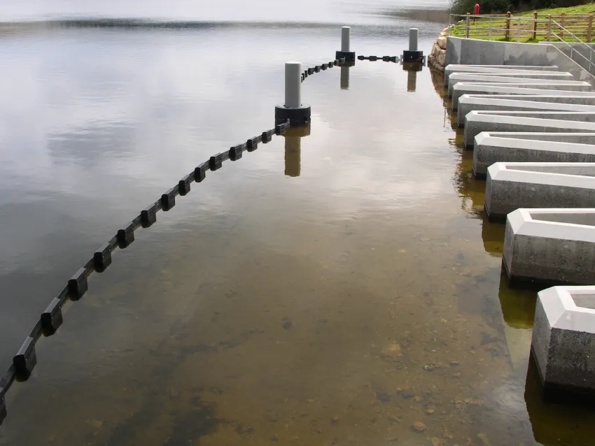Debris boom installed as a floating debris barrier near a water intake.