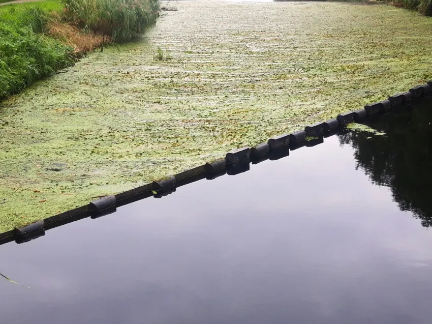 Floating debris barrier blocking floating debris in a canal
