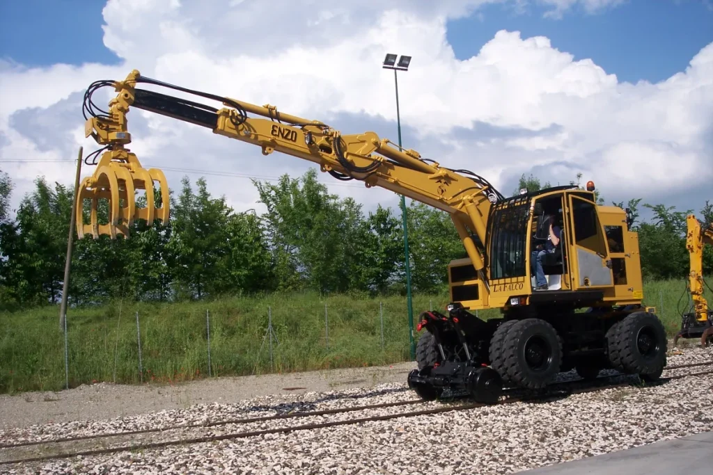 Hi rail excavator on railway tracks for maintenance