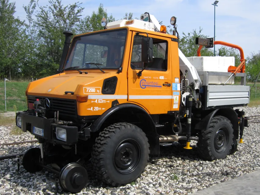 Hi rail vehicle on railway tracks with rail wheel equipment for maintenance operations.