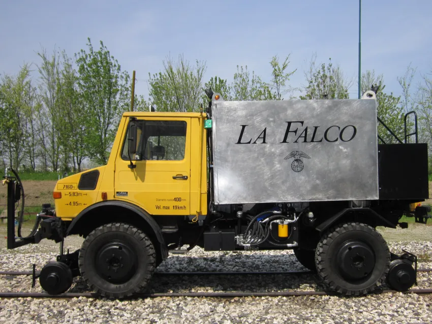Railroad hi rail truck on railway tracks with rail wheel equipment for infrastructure maintenance.