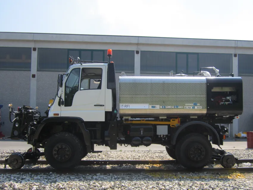 Railroad hi rail truck on railway tracks with rail wheel equipment for maintenance operations.