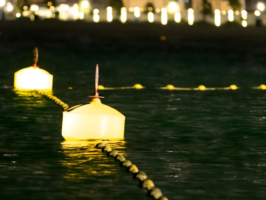 Lighted mooring buoy on water at night