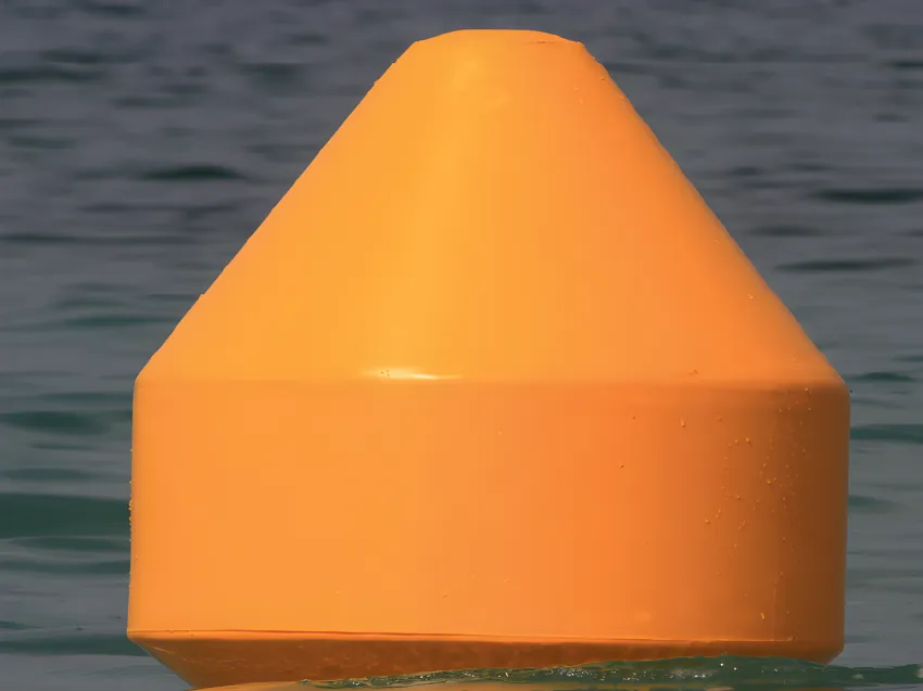 Close-up of floating mooring buoy on water
