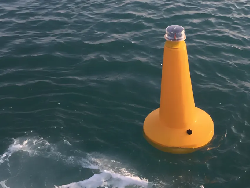 Yellow marine lantern buoy on water