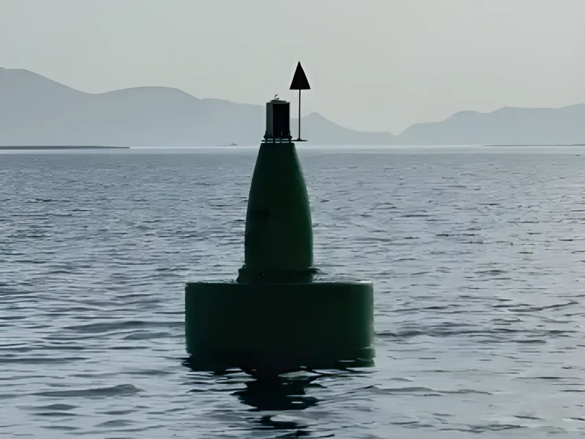 Green navigation buoy with arrow marker