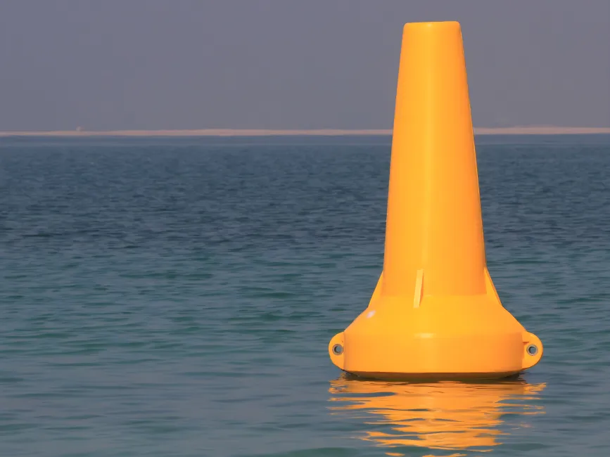 Yellow navigation buoy floating on water