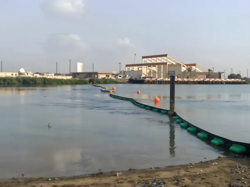 Permanent oil boom protecting industrial waterway