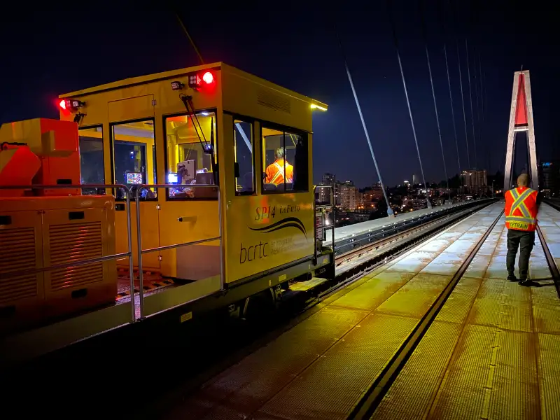 Rail shunter operating at night on a bridge track for railway maintenance and controlled rail movement.