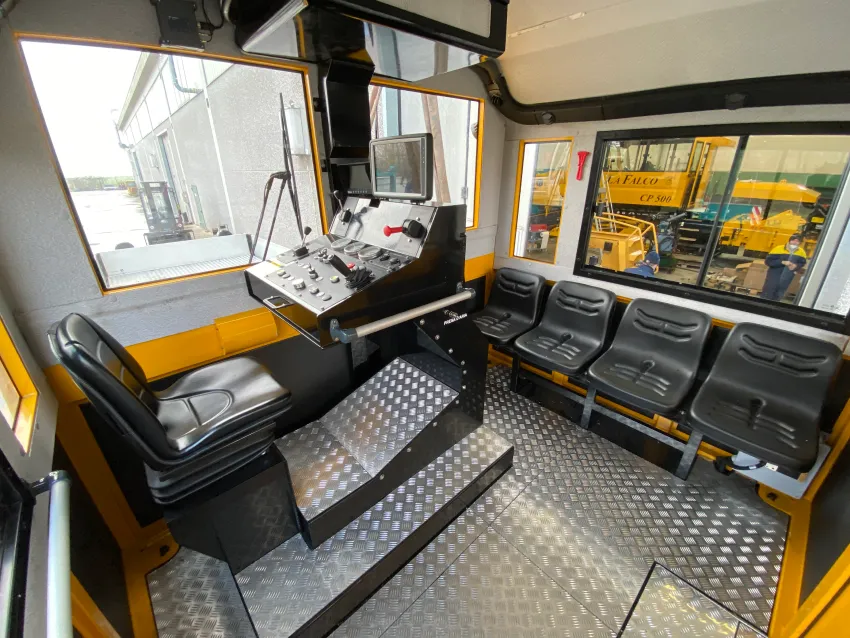 Railway shunter cabin with operator controls and seating for depot, yard, and industrial switching operations.