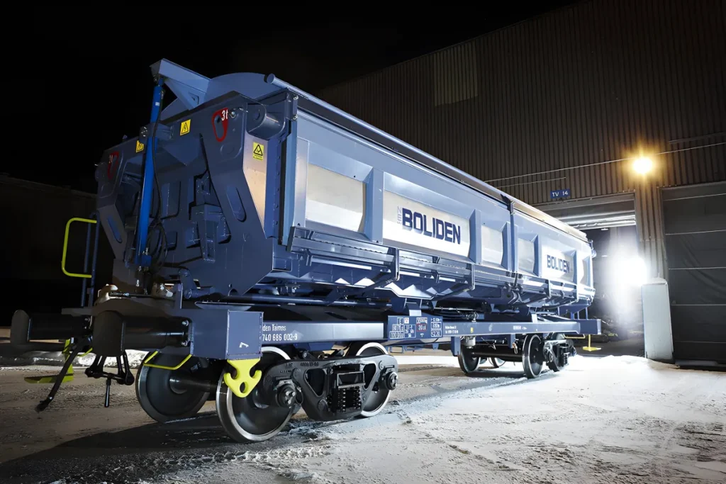 Side dumper freight wagon on rail track