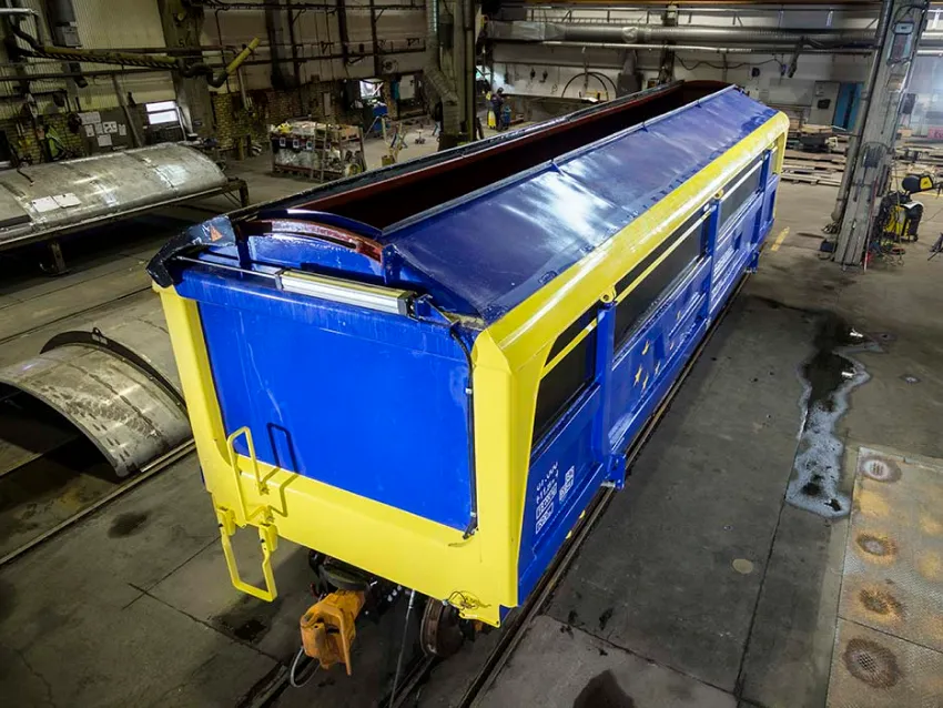 Blue side dumper freight wagon in workshop