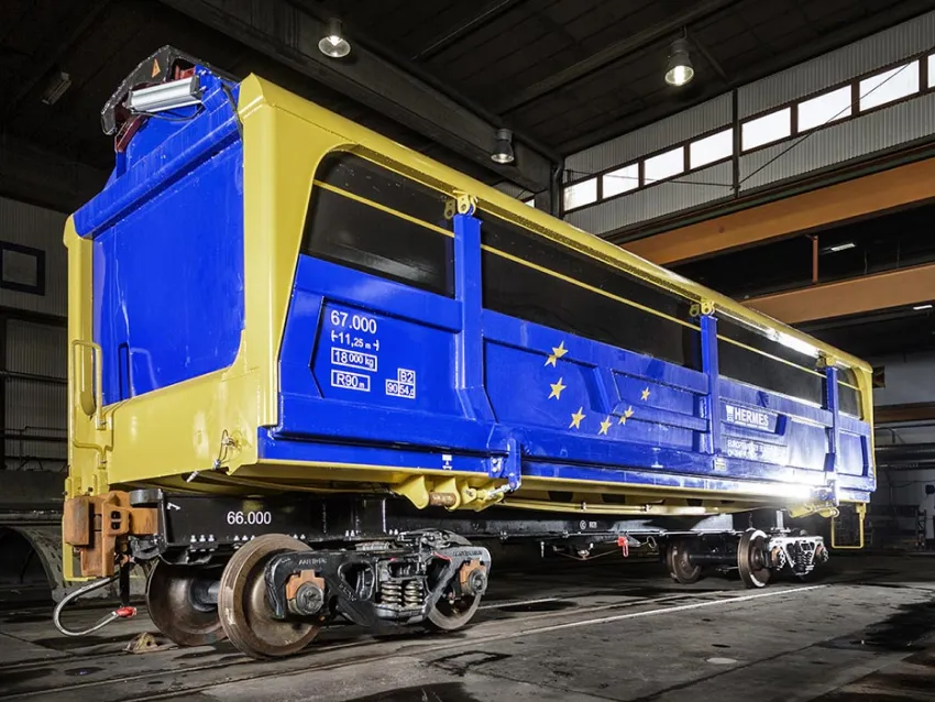 Blue side dumper freight wagon on rail track
