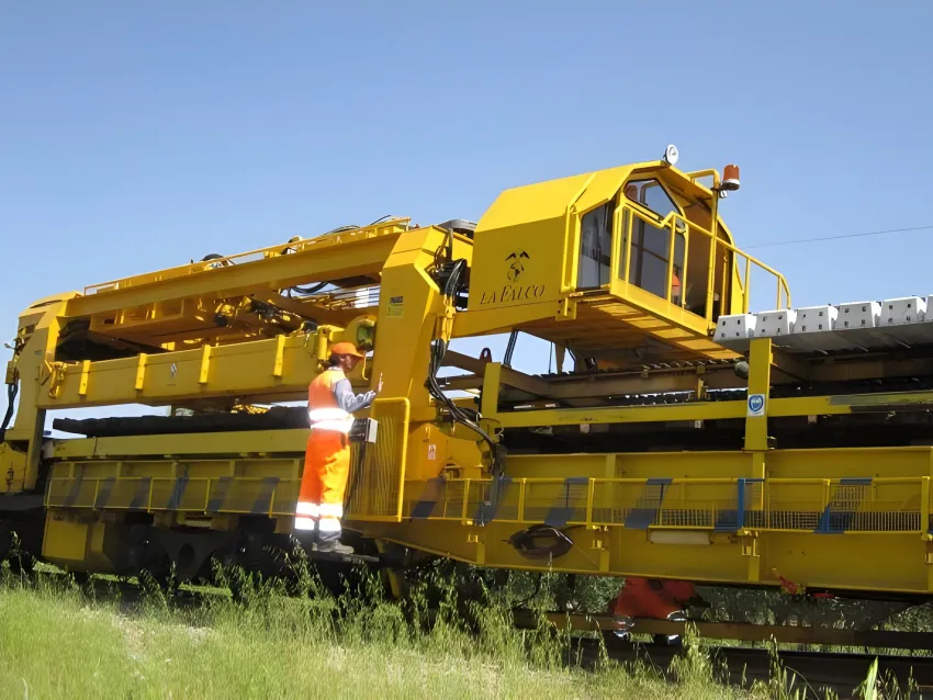 Sleeper gantry moving railway sleepers during track maintenance.