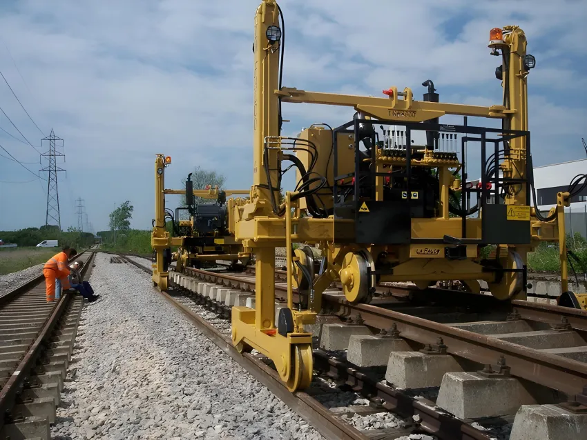 Track laying machine installing rails and sleepers on railway tracks.
