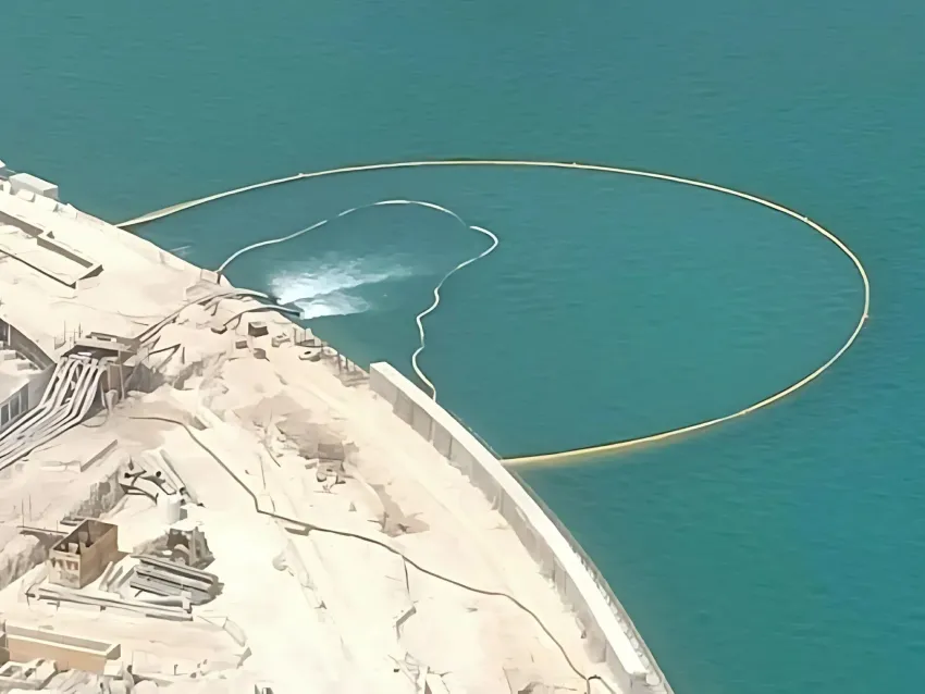 Circular turbidity curtain installed near shoreline for sediment control.