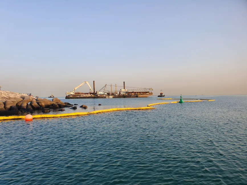 Premium silt curtain floating near marine construction for sediment control
