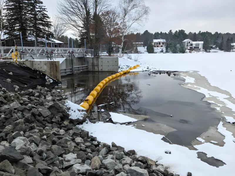 Waterway barrier installed near icy water infrastructure for watercraft safety