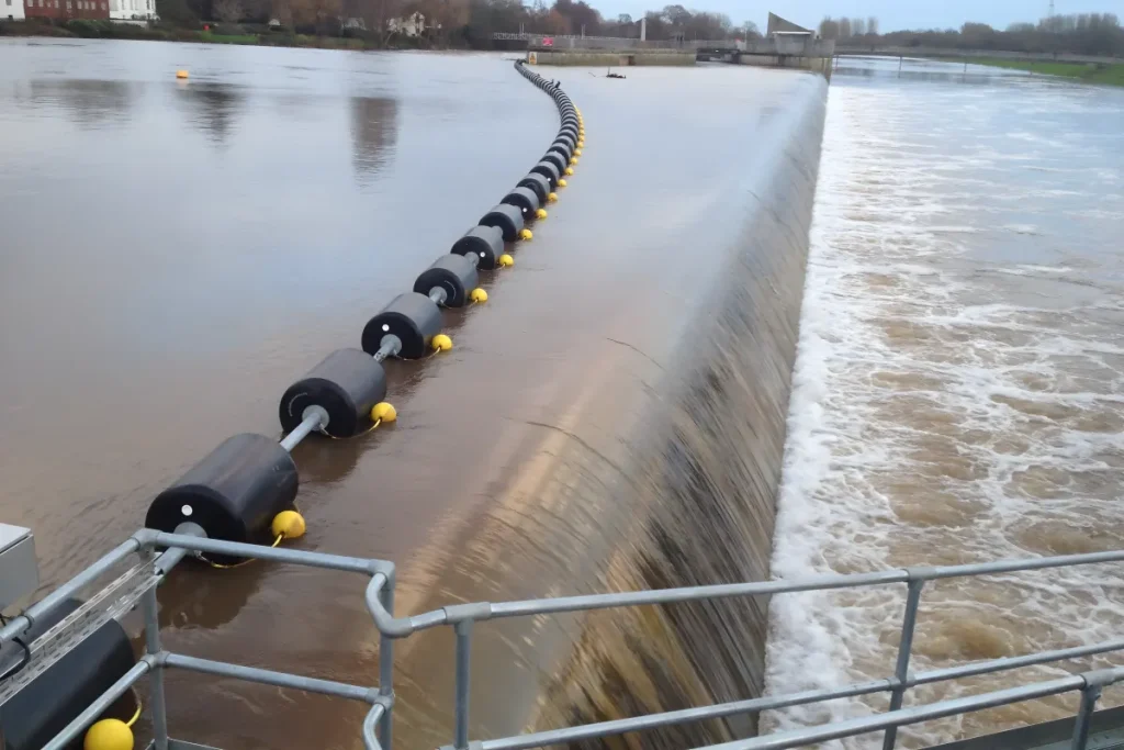 Waterway barrier installed near a dam for watercraft safety and traffic control