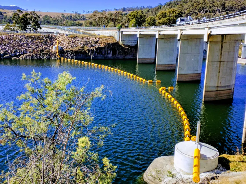 Dam boom installed as a waterway barrier for watercraft safety and traffic control