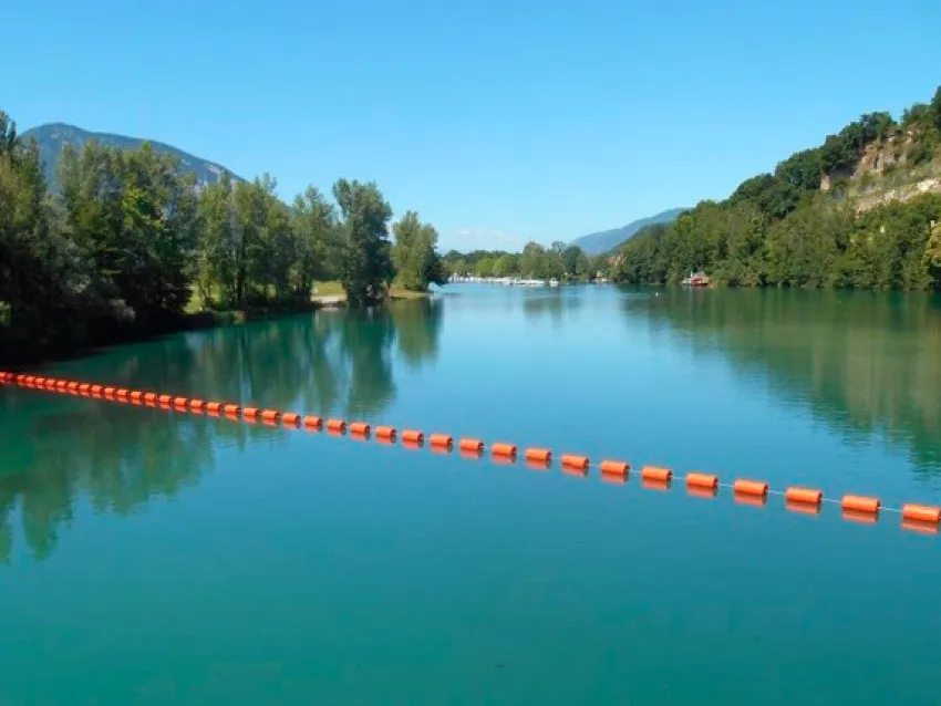 Waterway barrier installed across a river for watercraft safety and traffic control