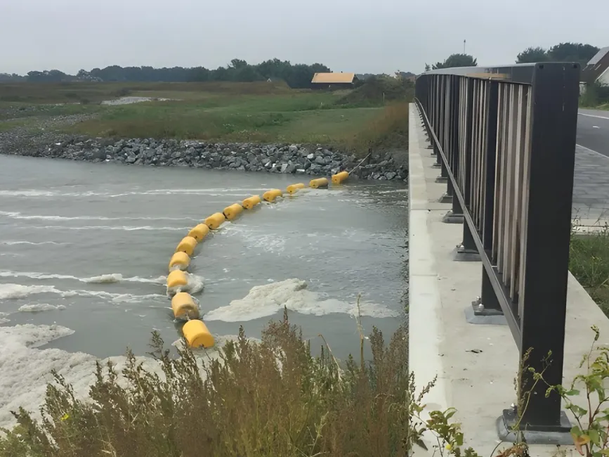 Waterway barrier installed near a bridge for watercraft safety and river traffic control