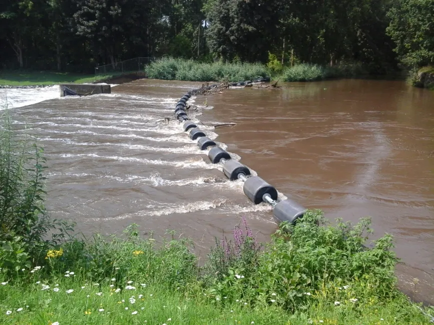 River boom installed across flowing water for watercraft safety and traffic control