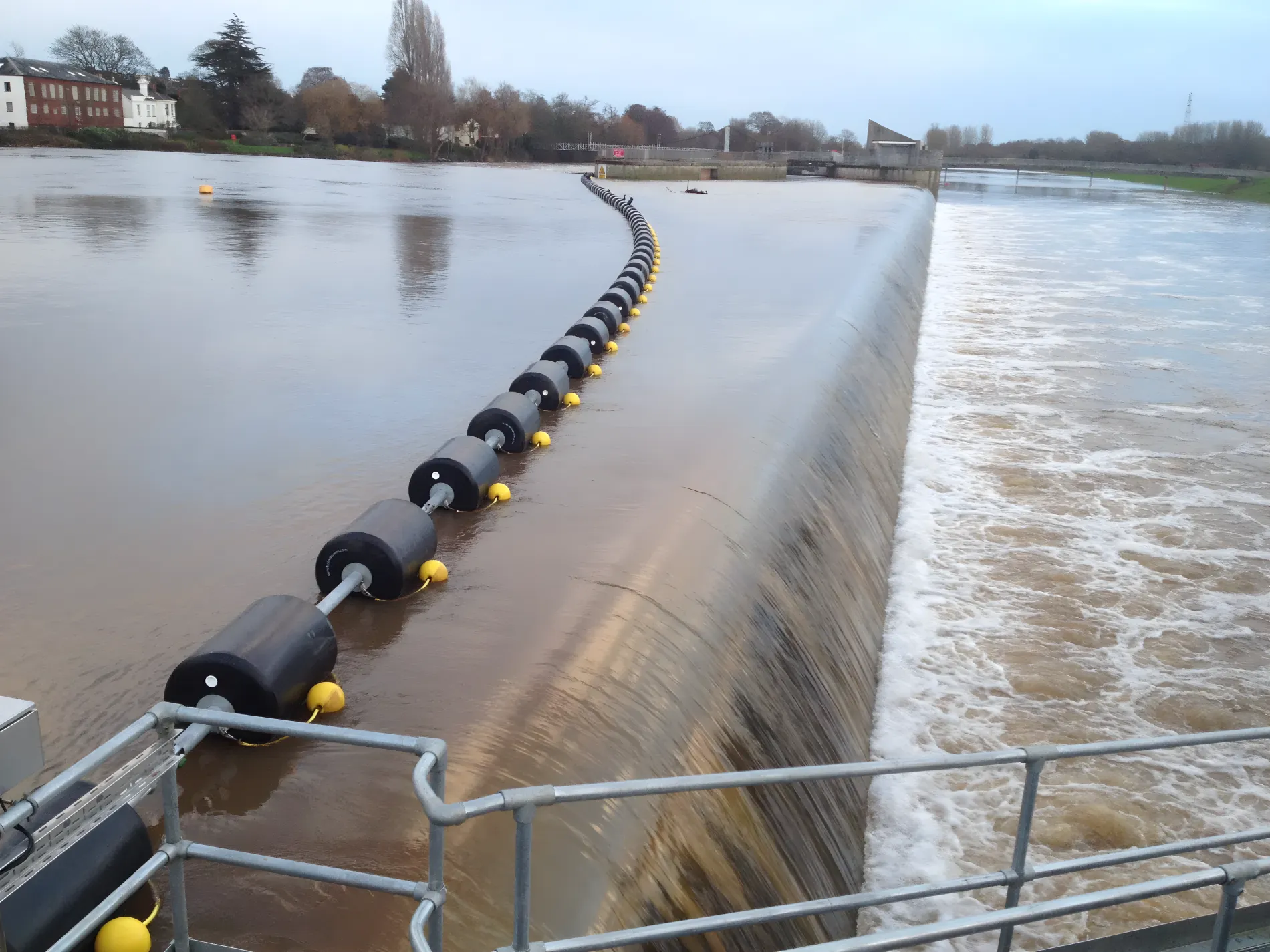 Waterway barrier installed near a dam for watercraft safety and traffic control